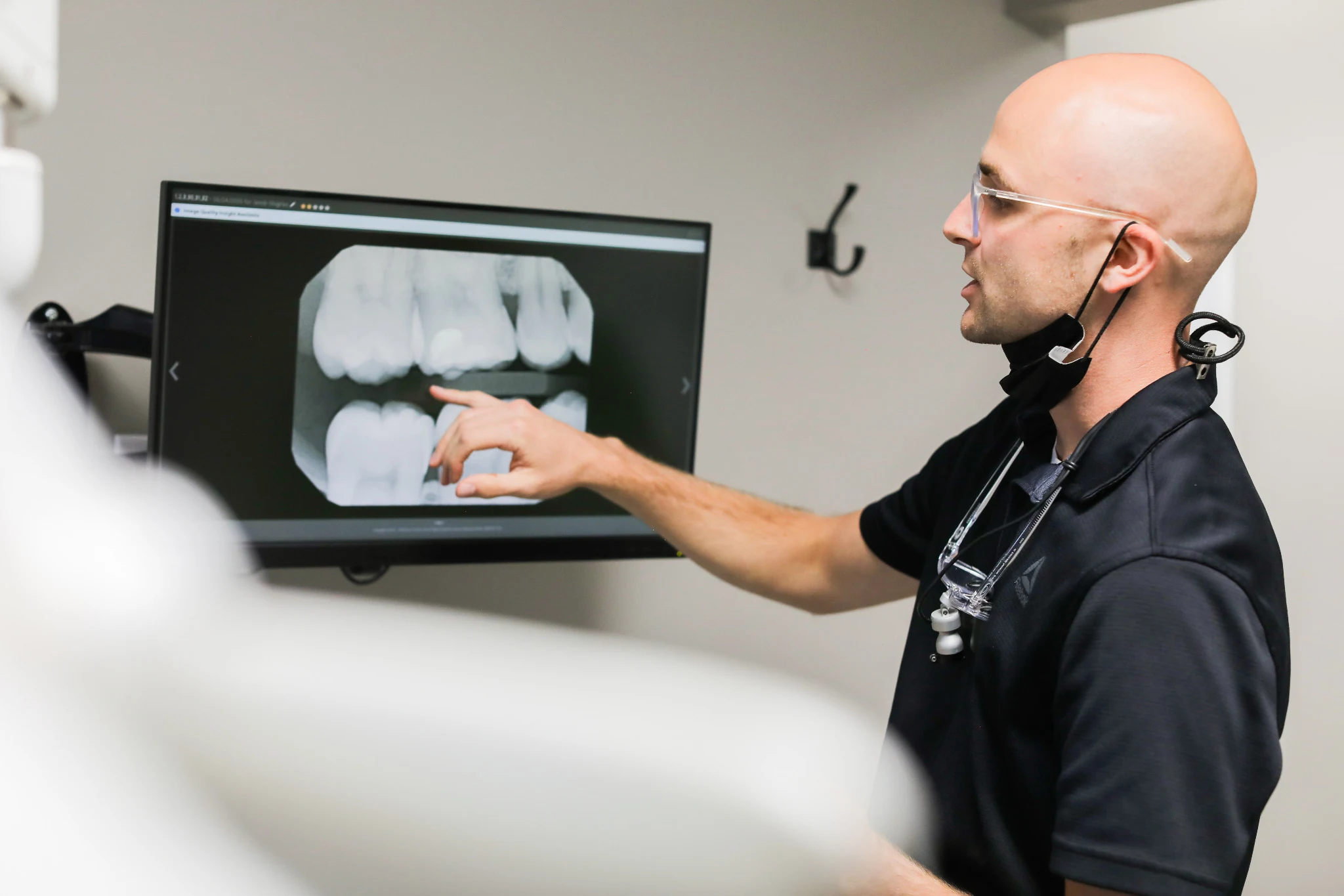A dentist explaining dental X-rays to a patient at Morton Family Dentistry
